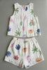 White sleeveless top and shorts set with colorful floral patterns on a gray background