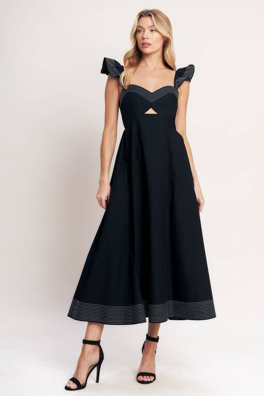 Woman wearing a black dress with cut-out design on a white background