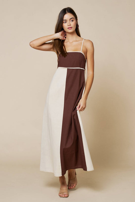 Woman wearing a two-tone dress with brown and white on a beige background