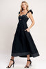 Woman wearing a black dress with cut-out design on a white background