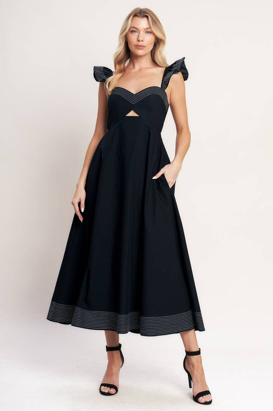 Woman wearing a black dress with cut-out design on a white background